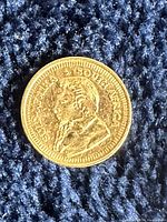 Obverse of the miniature gold Krugerrand showing bust of Paul Kruger and inscription ‘SUID-AFRIKA’/‘SOUTH AFRICA’