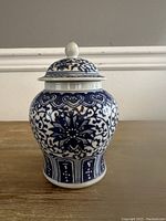 Front view of the blue and white lidded jar showing floral and geometric designs