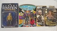 Three packaged action figures: Albert Einstein, Star Trek Borg and UFC Brock Lesnar, shown side by side on white background.