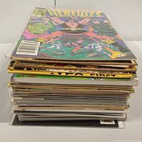 Stack of comic books showing thickness and assorted titles