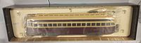 Full view of the streetcar model in original plastic and cardboard packaging showing overall condition and color.