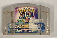 Front view of Pokemon Puzzle League Nintendo 64 cartridge with worn label and discoloration.