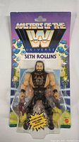 Front of packaging showing Seth Rollins WWE Masters of the Universe action figure in clear blister pack with colorful card backing.