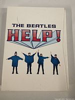 Front cover of the hardcover book showing 'The Beatles HELP!' title and band member images.