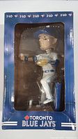 Front view of Troy Tulowitzki bobblehead figure in original packaging. The bobblehead shows the player in baseball uniform holding a glove and ball, boxed in clear plastic window.