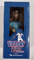 Front view of the box showing the bobblehead inside with the text 'Victory Vlad Bobblehead Presented by DoorDash'