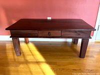 Front view of the Mission-style coffee table showing drawer with brass ring pull and tapered legs.