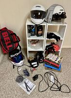 Full lot overview on cubed shelf with helmets, bag, gloves, books, accessories and shelves.