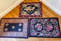 Three hooked throw rugs displayed together on the floor, showing pig, star, and floral patterns with size relation and border details.