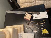 Overview of watch, bracelets, earrings and cake knife on table
