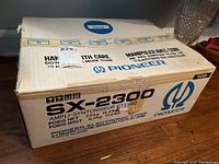 Original Pioneer SX-2300 stereo amplifier box with product labeling and weight information visible. Box made by Pioneer Electronic Corp in Japan.