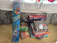 Seven boxed puzzles stacked on a surface, including a 1000-piece Las Vegas puzzle, mostly sealed in plastic wrap.