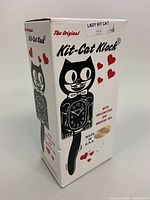Box front showing 'The Original Kit-Cat Klock' and black cat silhouette with hearts.