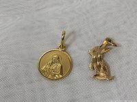 Both pendants on white fabric background, front view