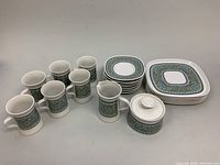 Full lot arranged showing all mugs, luncheon plates, saucers, creamer, and sugar bowl