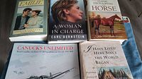 Photo showing six books including Emilie, A Woman in Charge, Classic Encyclopedia Horse, Canucks Unlimited, and I Have Lived Here Since the World Began, arranged on a surface