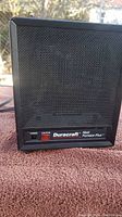 Front view of Duracraft Heat Furnace Plus space heater with black grille and red power switch.