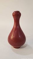 Front profile view showing overall shape and copper-red glaze