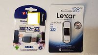 Both Lexar 128GB JumpDrive and Verbatim 32GB Nano USB OTG adapter in packaging.
