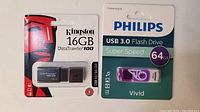 Both Kingston 16GB DataTraveler 100 and Philips 64GB USB 3.0 flash drives in sealed retail packaging.