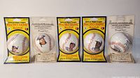 Front view of five Official Major League Photo Fame baseballs in original packaging showing photos of players: Lloyd Moseby, Willie Upshaw, Jesse Barfield, George Bell, and Ernie Whitt.