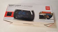 Box of RCA Soft Light Clock Radio showing front view with product image and features.
