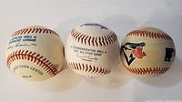 Three baseballs shown from top view highlighting text and logos including 1991 All-Star and Blue Jays logo ball