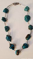Full view of turquoise nugget necklace showing large irregular turquoise stones strung on thin wire.
