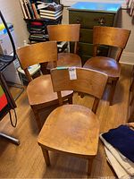 Four chairs arranged together, front view