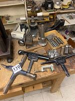 Overview of tools on workbench including Tri-Bender packaging, cast iron supports, forming blocks and stakes