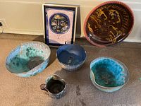 Full view of all six pieces grouped on carpet including three bowls, pitcher, pie plate and decorative plaque.