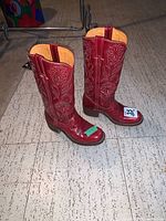 Pair of boots front and side view on floor