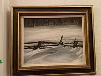 Framed painting showing a snow-covered fence and tree line in winter scene.