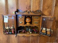 Front view of case with doors open and pipes displayed