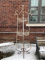 Front view showing full height and tier arrangement against brick wall with snow on ground