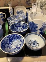 Full view of the set including pots, bowls, basket, candle holder, and side plate