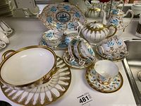 Overall layout of the porcelain set on counter showing all pieces