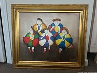 Full view of framed J. Roybal artwork on canvas showing group of five colorful, stylized figures in multicolored dresses set in a gold ornate frame.