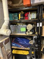 Full view of metal shelving with various stored items to illustrate size and shelf composition.