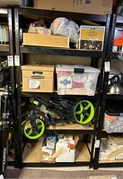 Full view of the metal shelving unit filled with various stored items showing its general condition and shelf layout.