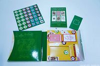 Top view showing multiple poker chips, two decks of playing cards, score pad, pencil, and the instructional book inside the box.