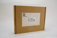 Closed cardboard box with Indigo Vision label showing part number and product details