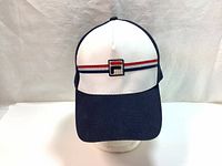 Front view of Fila baseball cap showing white front panel with red and blue stripes and central Fila logo patch.