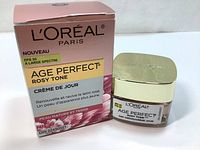 Photo showing the pink gradient box with French text and the glass jar with gold lid of L'Oreal Paris Age Perfect Rosy Tone Day Cream 50ml.