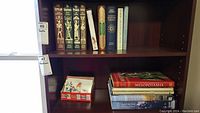 Wider view of the bookshelf containing historic and academic books including Folio Society editions and others.
