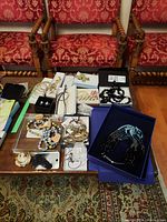 Full view of assorted costume jewelry displayed on a table, showing multiple necklaces, bracelets, hair clip, and key chain