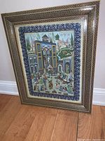 Front view of framed artwork showing entire frame and central painting