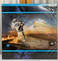 Photo showing the front of the sealed Back To The Future LaserDisc with movie artwork, sealed in shrink wrap.