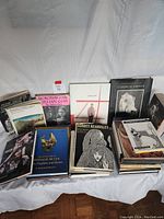 Wide shot of the art books collection showing various hardcover books with dust jackets, visibly titled "Classical Greece," "Aubrey Beardsley," and "The Sculpture of Donald De Lue" among others.