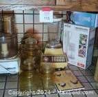 Photo showing kitchen counter with various vintage kitchen items including boxed Braun hand blender and hand chopper, and the glass canisters.